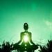 A silhouette of a person meditating with an open heart chakra under the sunlight