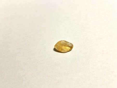 Piece of citrine crystal on white background