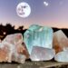 Crystals sitting outside in front of a full moon