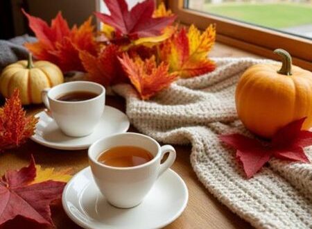 Cozy set up of tea cups, fall leaves, and pumpkins for a September ritual